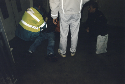 360057 Afbeelding van de verlening van medische hulp door ambulancepersoneel, vermoedelijk aan een dakloze en/of ...